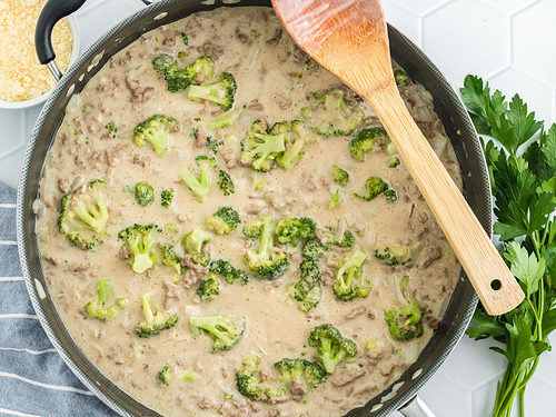 Ground beef, onions, garlic, broccoli, and alfredo sauce in a large skillet.