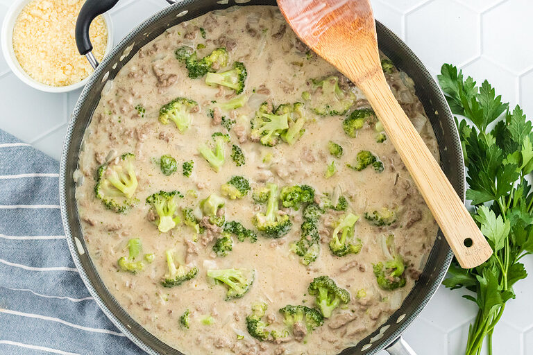 Ground beef, onions, garlic, broccoli, and alfredo sauce in a large skillet.