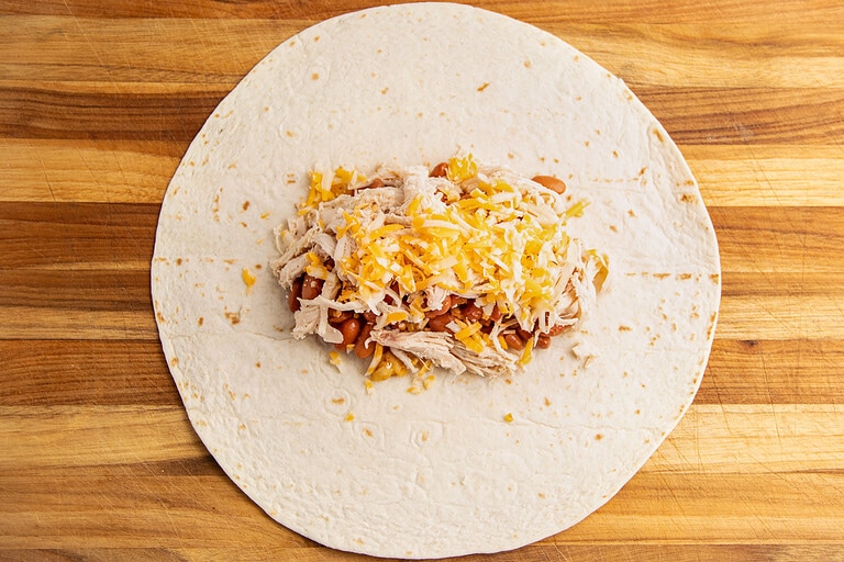 Large tortilla filled with burrito suizo filling.
