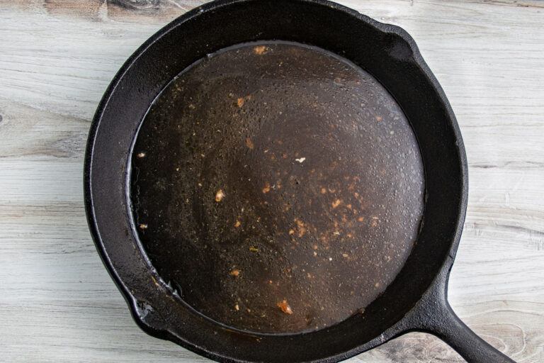 Chicken savoy sauce in a large cast-iron skillet.