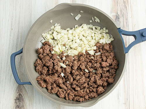 Ground beef and onion in large skillet.