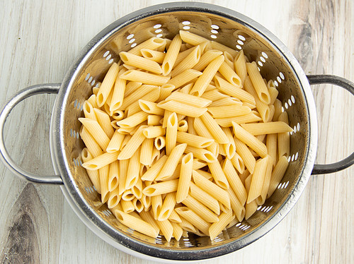 Cooked pasta in a colander.