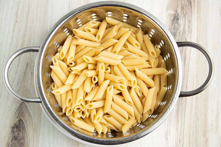 Cooked pasta in a colander.