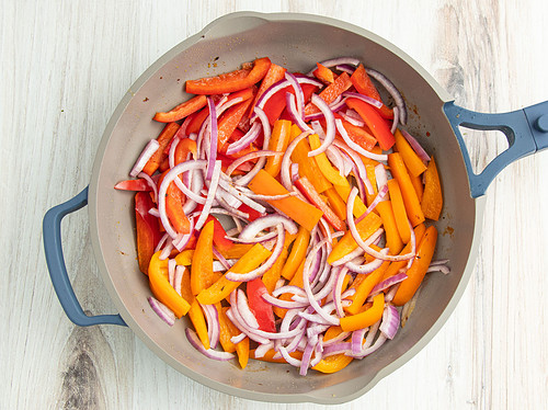 Peppers and onions in a large skillet.