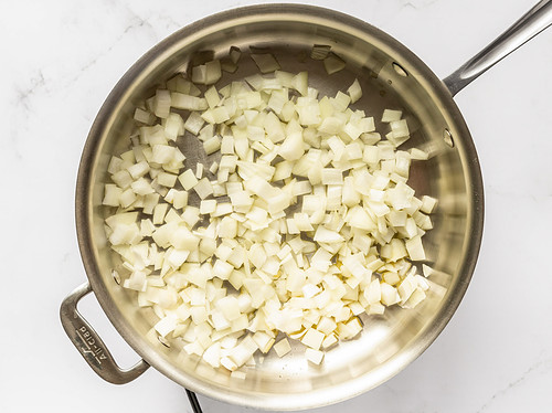 Diced onion in large silver saucepan with olive oil.