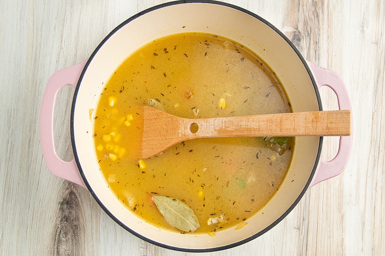 Veggies and broth in large pot.