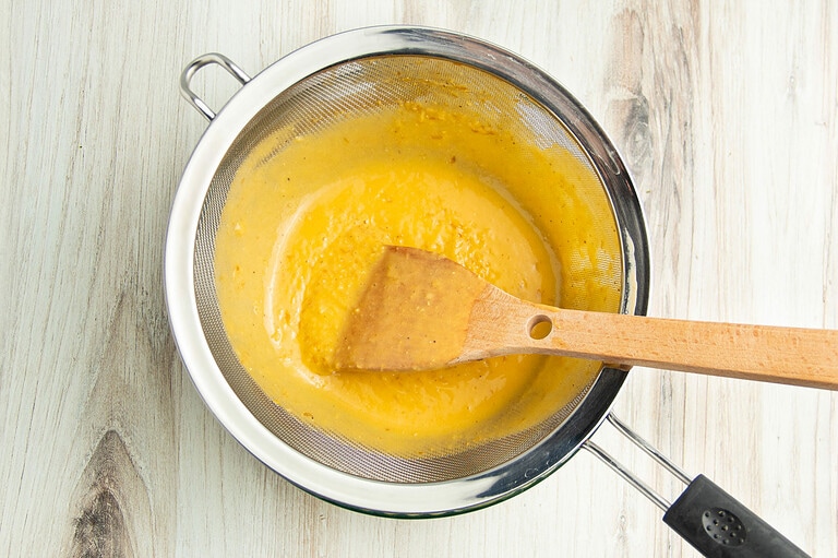 Soup strained into pot.