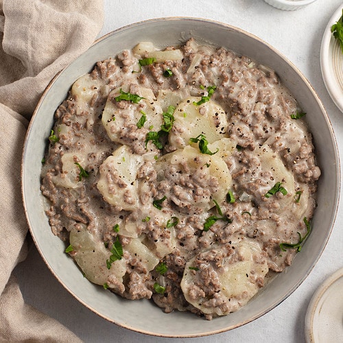 A large grey bowl of potato stroganoff with ground beef.