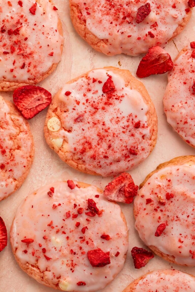 Strawberry cake mix cookies arranged on a sheet of parchment paper.