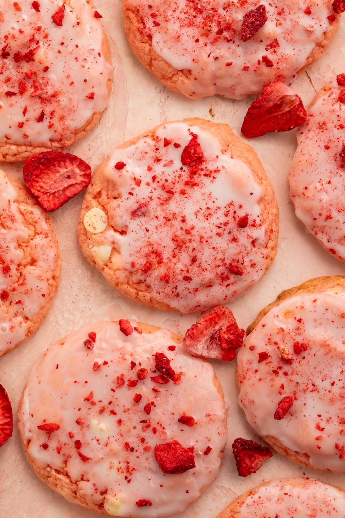 Strawberry cake mix cookies arranged on a sheet of parchment paper.