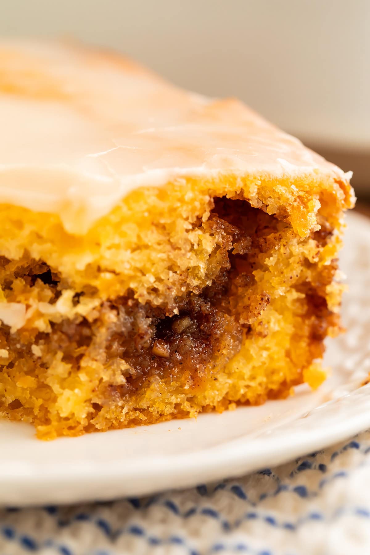 Close up of a slice of sweet potato honey bun cake showing the cinnamon swirl.