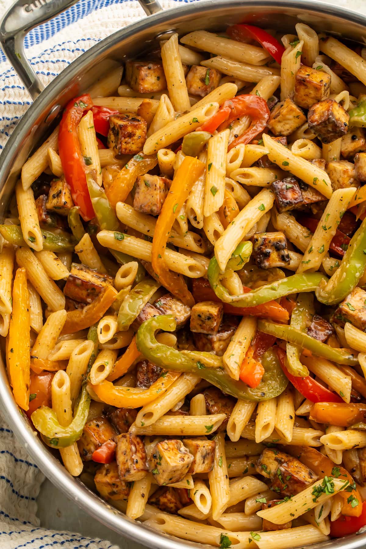Close up of a pan of rasta pasta made with penne and cubes of smoked tofu.