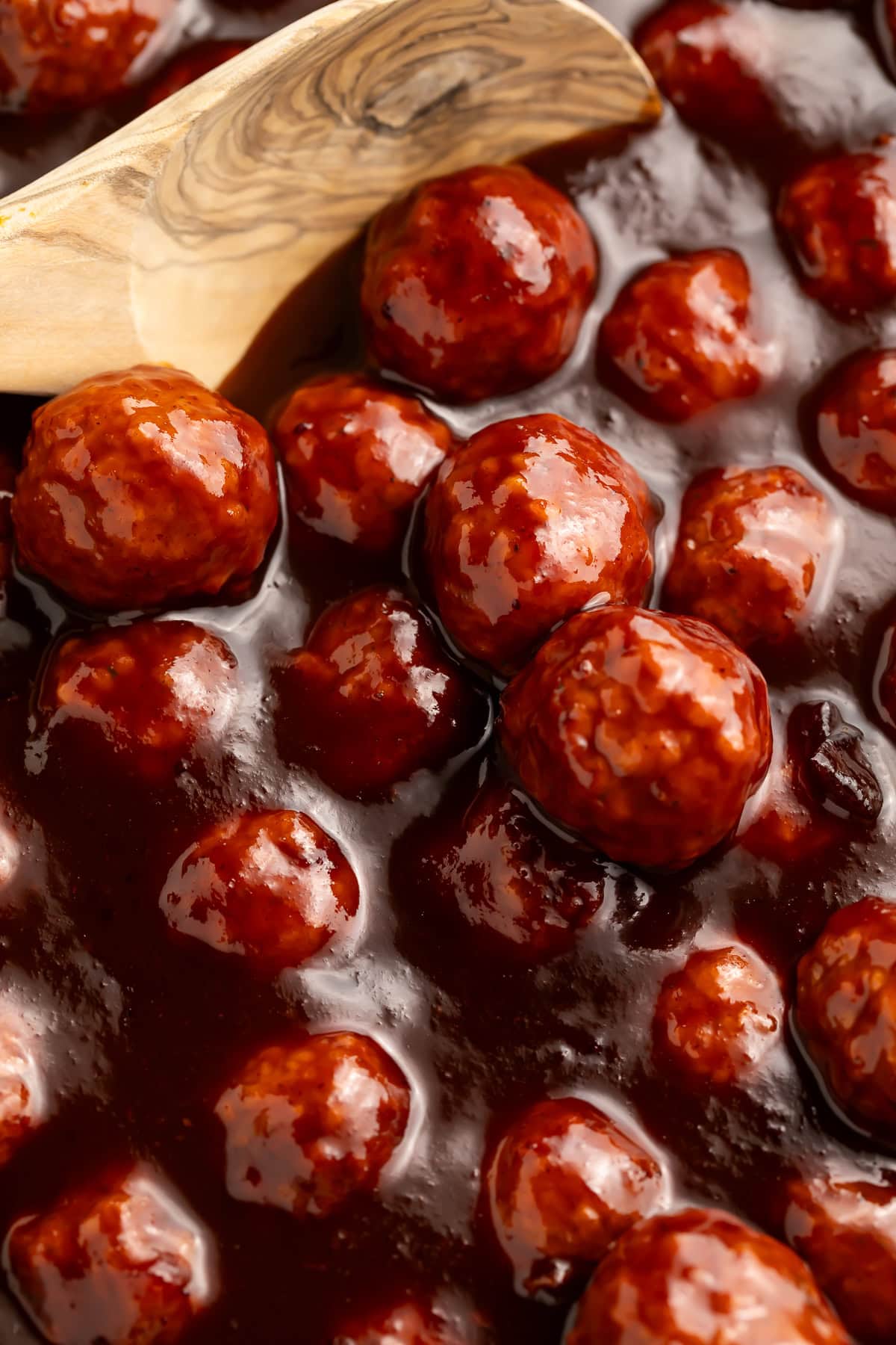 Close up of barbecue and cranberry meatballs in a sticky sauce.