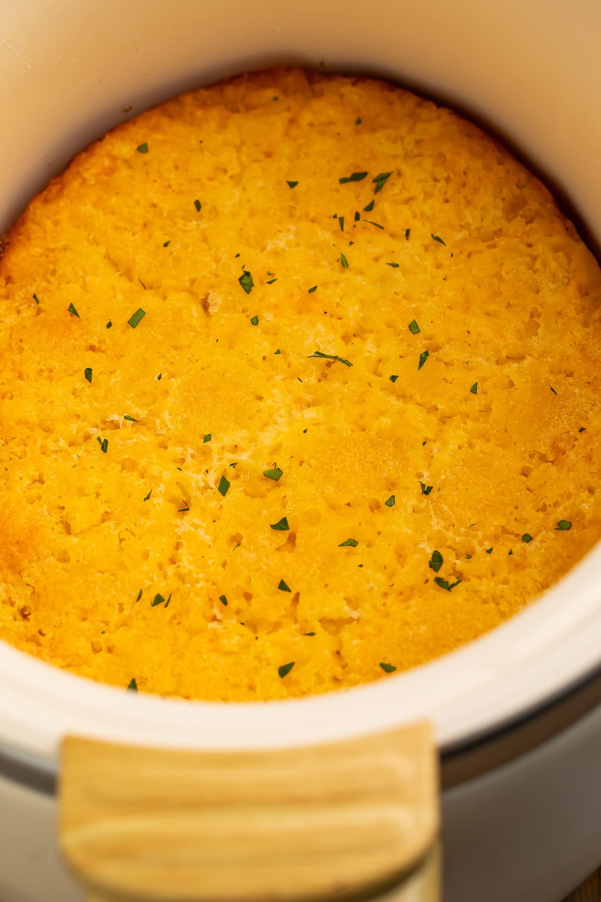 Close up of a corn casserole in a slow cooker.