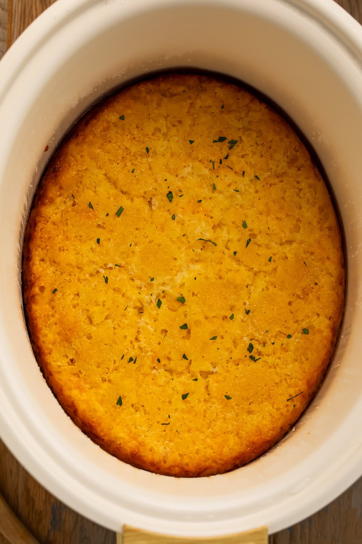 Corn casserole cooked in a slow cooker insert.